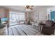 Bright living room with sliding glass doors to the porch, comfortable seating, and lots of natural light at 3249 Sunrise Trl, Port Charlotte, FL 33952