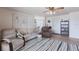 Comfortable living room featuring a striped rug, neutral furniture, and serene artwork at 3249 Sunrise Trl, Port Charlotte, FL 33952