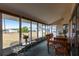 Enclosed porch with dining table and chairs overlooking the backyard at 3249 Sunrise Trl, Port Charlotte, FL 33952