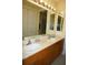 An ample double vanity bathroom showcasing a full mirror and vanity lighting at 3311 Purple Martin Dr # 126, Punta Gorda, FL 33950