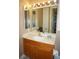 Bathroom with bright lighting, vanity, mirror, and linen cabinet at 3311 Purple Martin Dr # 126, Punta Gorda, FL 33950