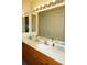 An ample double vanity bathroom showcasing a full mirror and vanity lighting at 3311 Purple Martin Dr # 126, Punta Gorda, FL 33950