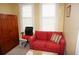 Cozy bedroom featuring a red couch, office chair, and ample natural light at 3311 Purple Martin Dr # 126, Punta Gorda, FL 33950