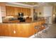 Cozy kitchen featuring wood cabinets, granite countertops, tile backsplash, and stainless steel appliances at 3311 Purple Martin Dr # 126, Punta Gorda, FL 33950
