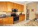 Contemporary kitchen featuring granite countertops, stainless steel appliances, and wood cabinetry at 3311 Purple Martin Dr # 126, Punta Gorda, FL 33950