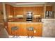 Functional kitchen featuring wood cabinets, granite counters, stainless steel appliances, and a breakfast bar at 3311 Purple Martin Dr # 126, Punta Gorda, FL 33950