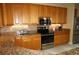Modern kitchen with granite countertops, stainless steel appliances, and wood cabinetry at 3311 Purple Martin Dr # 126, Punta Gorda, FL 33950