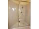 A tiled walk-in shower with neutral wall tiles and a frameless glass door at 3311 Purple Martin Dr # 126, Punta Gorda, FL 33950