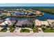 Aerial view of a luxurious waterfront property with a private boat dock, lush landscaping, and a circular driveway at 3657 Aruba Ct, Punta Gorda, FL 33950