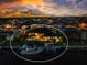 Waterfront home featuring a boat dock, pool and serene backyard at dusk at 3657 Aruba Ct, Punta Gorda, FL 33950