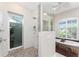 Walk-in shower with pebble floor and glass doors in luxury bathroom at 3657 Aruba Ct, Punta Gorda, FL 33950