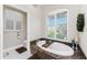 Relaxing bathroom with soaking tub beneath a window with light-filtering shutters at 3657 Aruba Ct, Punta Gorda, FL 33950