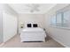 Bright bedroom with a white bed frame, ceiling fan, and double door closet at 3657 Aruba Ct, Punta Gorda, FL 33950