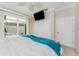 Bedroom with white bedding, a blue blanket, large closet, and a door to an outdoor space at 3657 Aruba Ct, Punta Gorda, FL 33950