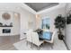 Bright dining room features a modern light fixture and a decorative fireplace at 3657 Aruba Ct, Punta Gorda, FL 33950