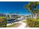 Waterfront home with a private boat dock and lift, complemented by well-maintained landscaping and clear blue skies at 3657 Aruba Ct, Punta Gorda, FL 33950