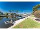 Features a private boat dock with lift, surrounded by lush green lawns and a tranquil waterfront setting at 3657 Aruba Ct, Punta Gorda, FL 33950