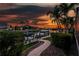 Docked boat on beautiful canal setting at sunset with lush landscaping and plenty of room to entertain at 3657 Aruba Ct, Punta Gorda, FL 33950