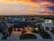 Stunning exterior shot of home and manicured front yard with brick driveway and lush landscaping at dusk at 3657 Aruba Ct, Punta Gorda, FL 33950
