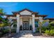 Elegant home featuring a modern front entry with stone pillars, a glass door, and manicured landscaping at 3657 Aruba Ct, Punta Gorda, FL 33950