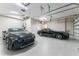 Spacious garage with two luxury vehicles and overhead lighting fixtures at 3657 Aruba Ct, Punta Gorda, FL 33950