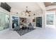 Open-concept lanai with multiple seating areas, outdoor kitchen, and access to the living room at 3657 Aruba Ct, Punta Gorda, FL 33950
