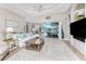 Bright and airy living room with a view of the pool and patio through sliding glass doors at 3657 Aruba Ct, Punta Gorda, FL 33950