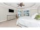 Comfortable main bedroom featuring ceiling fan and view to the pool area at 3657 Aruba Ct, Punta Gorda, FL 33950