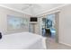 Bedroom featuring slider doors that open up to a screened-in pool and water view at 3657 Aruba Ct, Punta Gorda, FL 33950