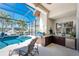 Screened-in lanai features an outdoor kitchen, mini-fridge, stainless grill, and relaxing poolside lounging at 3657 Aruba Ct, Punta Gorda, FL 33950