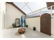 Enclosed patio space with a surfboard, unique coffee table and a wooden entry gate at 3657 Aruba Ct, Punta Gorda, FL 33950