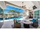 Screened-in outdoor area featuring a swimming pool, spa, and seating area with a fire pit at 3657 Aruba Ct, Punta Gorda, FL 33950