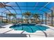 The screened-in lanai features a luxurious pool, spa, and views of the canal at 3657 Aruba Ct, Punta Gorda, FL 33950