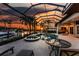 Beautiful lanai with pool, spa, outdoor seating, and bar featuring sunset views at 3657 Aruba Ct, Punta Gorda, FL 33950