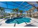Relax in the screen-enclosed lanai with its beautiful pool, spa, and waterfront view of the canal at 3657 Aruba Ct, Punta Gorda, FL 33950
