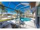 Relax on the lanai with pool, spa, table and chairs, lounge seating, and a view of the canal at 3657 Aruba Ct, Punta Gorda, FL 33950