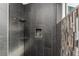 Tile shower featuring a rainfall shower head, a built-in niche, and mosaic tile accents at 3657 Aruba Ct, Punta Gorda, FL 33950
