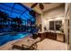Beautiful outdoor summer kitchen with cabinets and grill on screened in lanai by pool at 3657 Aruba Ct, Punta Gorda, FL 33950