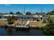 Waterfront property with dock, screened pool, outdoor bar, lush landscaping and neighborhood setting at 4238 Gardner Dr, Port Charlotte, FL 33952