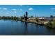 Aerial view of waterfront property with dock, screened-in pool, and lush surroundings at 4238 Gardner Dr, Port Charlotte, FL 33952
