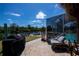 View of backyard showing large screened-in lanai and pool along the water at 4238 Gardner Dr, Port Charlotte, FL 33952