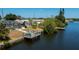 Waterfront backyard features a screened-in pool, dock with seating, and canal access at 4238 Gardner Dr, Port Charlotte, FL 33952