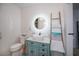 Bright bathroom with decorative mirror, tiled accent wall, vanity, and decorative ladder at 4238 Gardner Dr, Port Charlotte, FL 33952