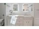 All-white bathroom with double farmhouse sinks and modern fixtures at 4238 Gardner Dr, Port Charlotte, FL 33952