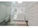 All-white bathroom with a glass shower, skylight, and dual sinks at 4238 Gardner Dr, Port Charlotte, FL 33952