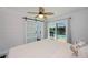 Bright bedroom with a view of the pool, sliding barn door, and a ceiling fan at 4238 Gardner Dr, Port Charlotte, FL 33952