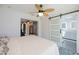 Open bedroom with sliding barn door, ceiling fan, and ensuite bathroom at 4238 Gardner Dr, Port Charlotte, FL 33952