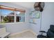 Bedroom showing backyard view with tiki bar, accent wall, and ceiling fan at 4238 Gardner Dr, Port Charlotte, FL 33952