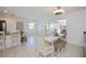 Bright kitchen and dining area with white tile, breakfast bar, and clear view to the living room at 4238 Gardner Dr, Port Charlotte, FL 33952