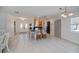Open concept kitchen and dining area with white tile flooring and elegant pendant lighting at 4238 Gardner Dr, Port Charlotte, FL 33952